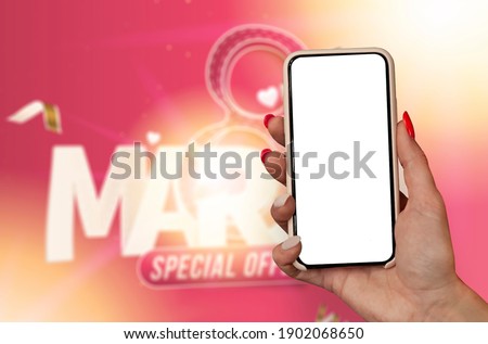 8 March International women's day. A woman holds a mockup of a smartphone in her hands on the background of a greeting card