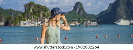 BANNER, LONG FORMAT Attractive woman in a dress is traveling in Halong Bay. Vietnam. Travel to Asia, happiness emotion, summer holiday concept. Picturesque sea landscape. Ha Long Bay, Vietnam