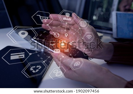 Double exposure of business hand using digital tablet with laptop computer and business financial innovation virtual chart, Digital marketing concept, Blurred background.