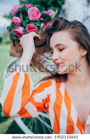 color image of a girl on a spring lawn with flowers