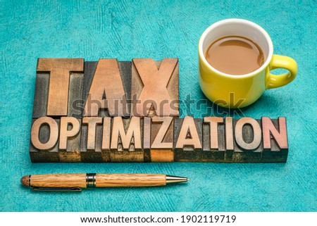 tax optimization, financial concept in vintage letterpress wood type with coffee, business and tax planning