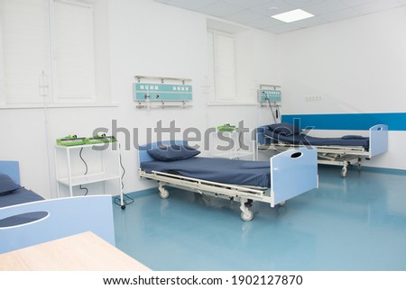 Empty modern hospital room for several patients. Modern medical equipment in the intensive care unit Royalty-Free Stock Photo #1902127870