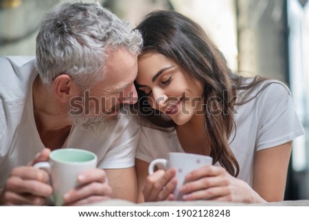 Enjoying tenderness. A lovely couple having their mornng coffee together Royalty-Free Stock Photo #1902128248