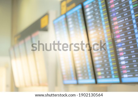 Blurred departure arrival board in airport terminal. Blur domestic and international flight information timetable. Transportation building background.