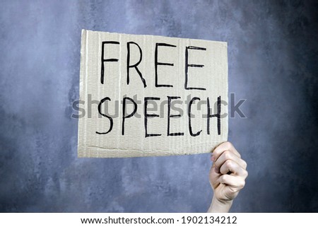 hand holds a banner with the inscription free speech, censorship concept Royalty-Free Stock Photo #1902134212