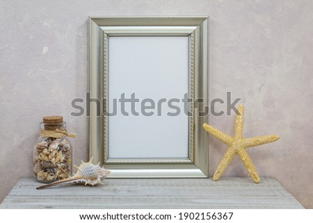 Silver Frame Mockup with with seashells against pink textured wall for spring, summer, sea, seashore, beach, vacation, holiday, party theme.