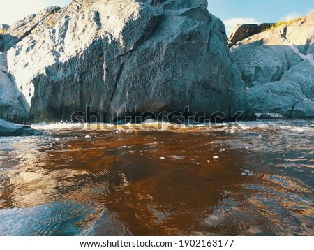 PHOTOGRAPH OF A RIVER AMONG THE ROCKS IN CORDOBA ARGENTINA