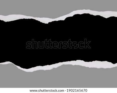 Ripped grey paper on black background, space for copy Royalty-Free Stock Photo #1902165670
