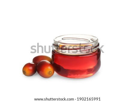 Palm oil in glass jar and fruits isolated on white
