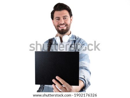 Young handsome student Man showing blank sign board over white background.