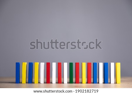 many colorful wooden building blocks on grey background