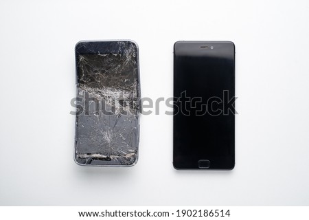 Mobile smartphone with broken screen on white background. Repairs concept.
