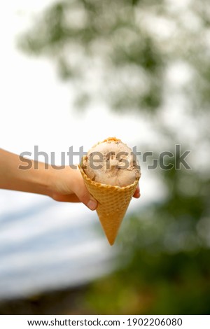 Delicious traditional ice cream in hands. Natural homemade ice cream close-up. Summer sweet delicious dessert. Refreshes in hot weather. Healthy food, natural products.