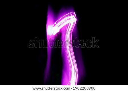 Long exposure photography. Writes 1 with pink light on black background. Neon lights wallpaper.