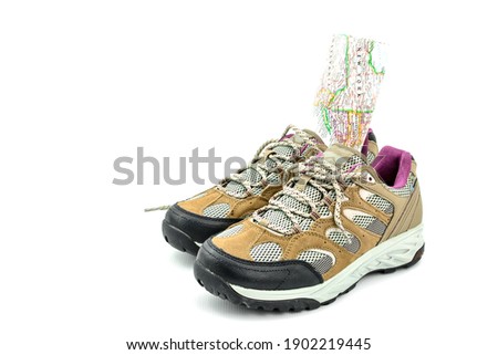 photo of pair sport walking boots and map