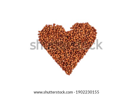 Buckwheat heart isolated on white background. Buckwheat in the shape of a heart. Photography for design. Valentines day concept.