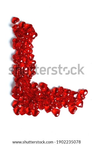 The inscription love is made of red glass hearts. Isolate on a white background. The Letter L