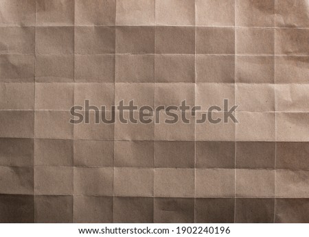 Folded brown paper texture. Top view.