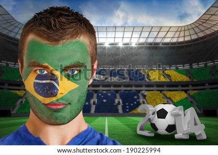 Composite image of serious young brasil fan with face paint against large football stadium with brasilian fans
