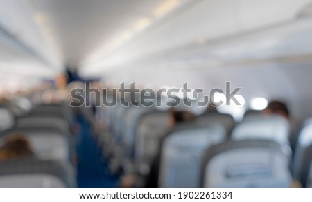Interior of airplane cabin looking down the aisle