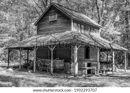 Old wooden tobacco barn in black and white