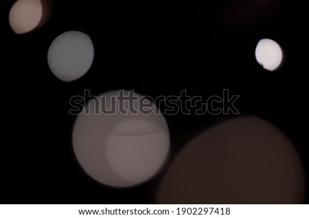 Light dots with a black background. Blur decoration bokeh lens bright with colours. Non focused composition