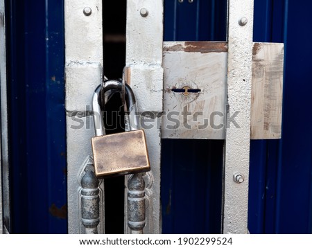 Padlock with metal rustic door. Concept of security, business closed.