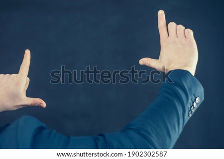Businessman in a shirt and a blue jacket shows gestures with his hands