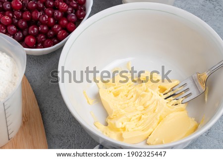 Making a dough for a sweet cranberry pie. Melted butter in a bowl