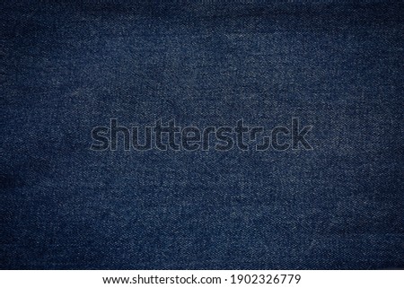 surface of dark navy blue denim jeans fabric for background. Royalty-Free Stock Photo #1902326779