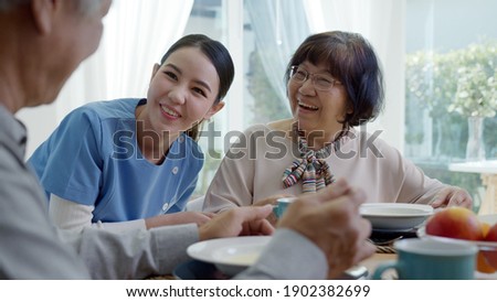 Attractive young senior asian citizen couple happy sit, talk, eat soup for healthy nutrition breakfast meal on dining table at home in morning in routine lifestyle in old asia nursing in-home care. Royalty-Free Stock Photo #1902382699