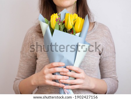 girl with bouquet of tulips in hands 
