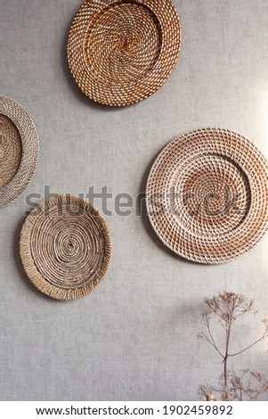 round straw elements on a grey wall