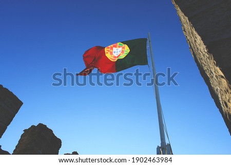 the flag of portugal on a castle