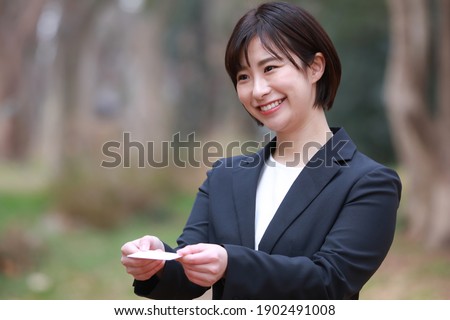 Female employees exchanging business cards 