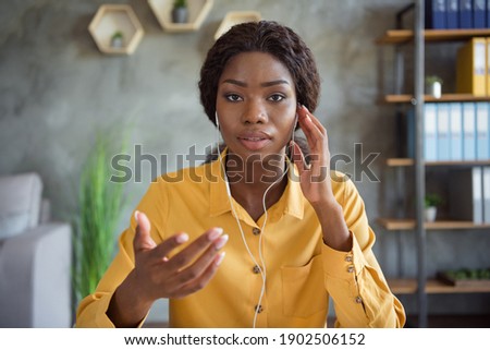 Photo of afro american business woman wear headphones online conference job in office indoors workplace