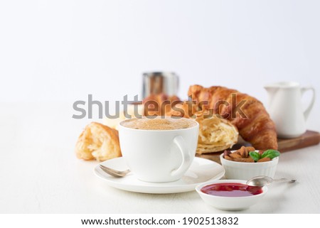 Fresh delicious breakfast with Coffee, crispy croissants, jam on white wooden background. Selective focus. Romantic french weekend concept. Copy space. Royalty-Free Stock Photo #1902513832