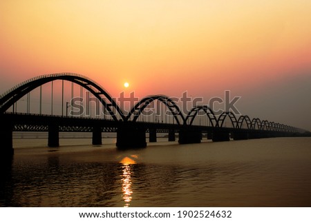 The Godavari Arch Bridge is a bowstring-girder bridge that spans the Godavari River in Rajahmundry, India. It is the latest of the three bridges that span the Godavari river at Rajahmundry. Royalty-Free Stock Photo #1902524632