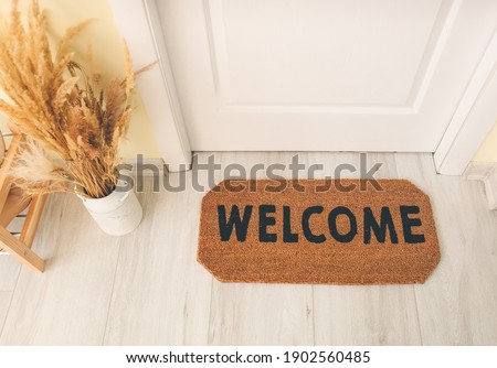 Door mat on floor in hallway Royalty-Free Stock Photo #1902560485