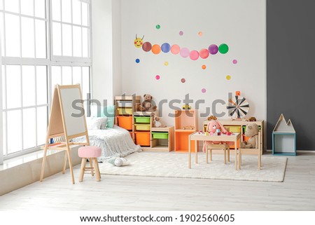 Stylish interior of modern playroom in kindergarten Royalty-Free Stock Photo #1902560605