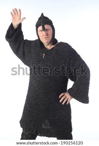 portrait of adult bald white man in chain mail and a helmet on a light background studio