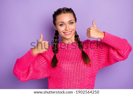 Photo of cheerful attractive young woman raise thumbs up recommend product isolated on purple color background