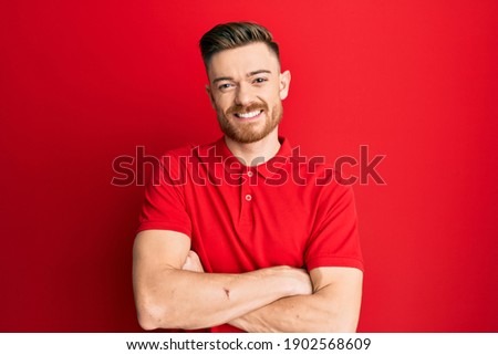 Young redhead man wearing casual clothes happy face smiling with crossed arms looking at the camera. positive person. 