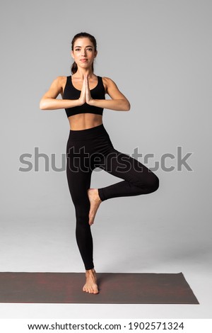 Beautiful woman in fitness cloth doing yoga and meditation isolated on white background.