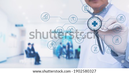 Doctor with stethoscope and modern virtual screen interface, medical technology network with hospital interior as background, smart health, virtual hospital, online medical, telemedicine concept Royalty-Free Stock Photo #1902580327
