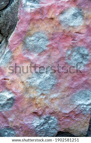texture of stone painted with silver and pink paint