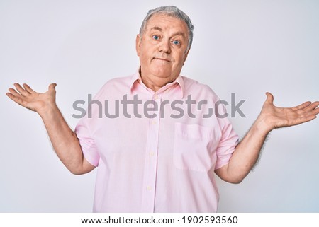 Senior grey-haired man wearing casual clothes clueless and confused with open arms, no idea and doubtful face. 