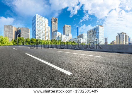 Asphalt road and modern commercial buildings in Beijing,China.