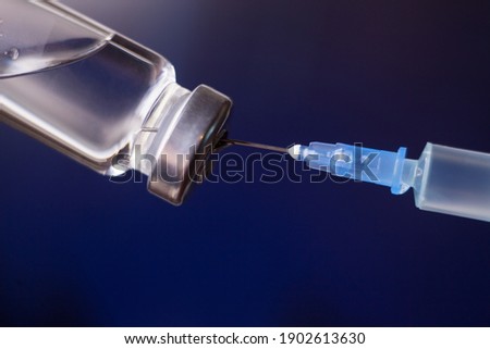 Vaccination against the new Corona Virus SARS-CoV-2: A syringe being drawn up with SARS-CoV-2 vaccination. Medical concept.