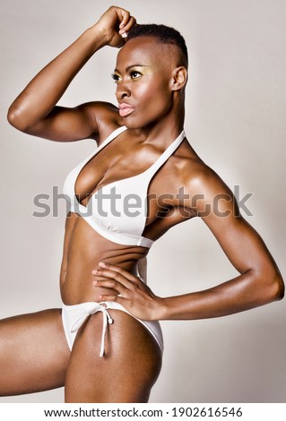 Young african woman posing in white bikini